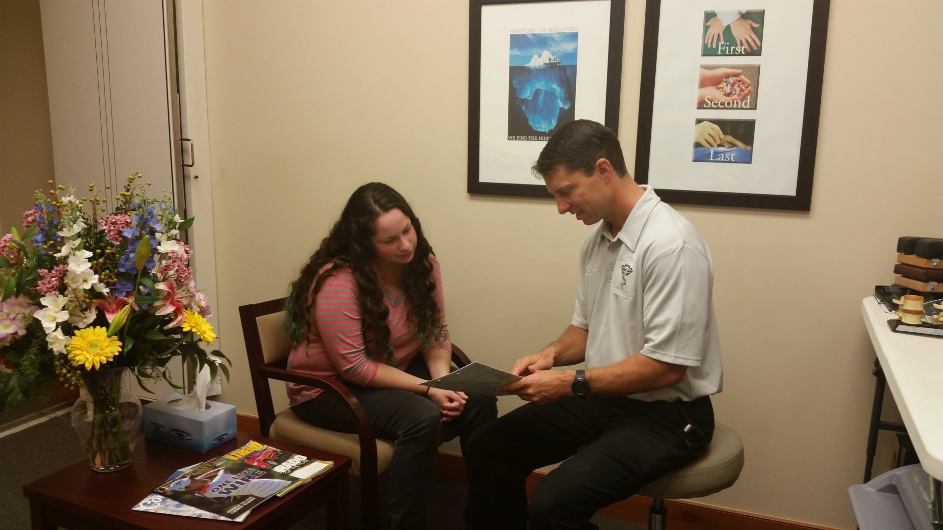 A woman having a consult with a chiropractor